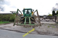 Photo 6x4 Tractor and Grass Harrows entering the Homestead Farm Woottons  c2012