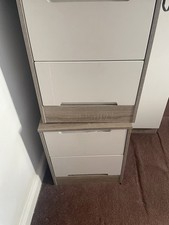 A  Cream Off Grey Wardrobe  Which Has Different Departments For Clothing
