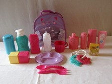 TODDLERS BACKPACK FILLED WITH ASSORTED DOLLS ACCESSORIES FOR A BABY DOLL.