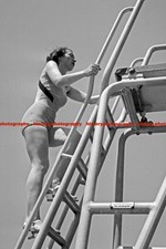 F000496 Woman climbing on a diving board at an open air swimming pool BdM German