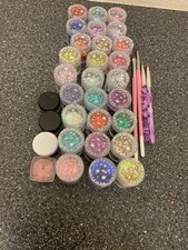 30 pots of nail glitter and 4 nail art brushes. Please read description.