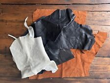 Leather scraps, scrap pieces, black and white, with one brown piece faux suede