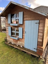 Wooden Wendy House For The Garden With An Upstairs Room.