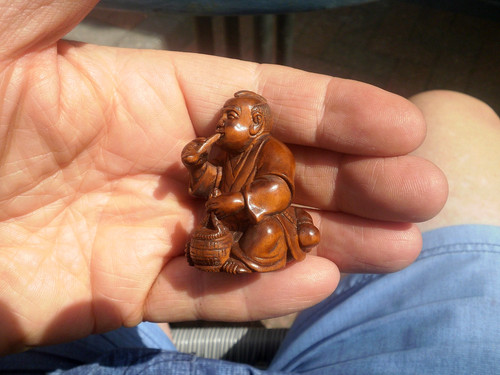 Hand carved wood netsuke man - hand,