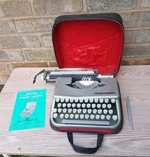 EMPIRE CORONA PORTABLE TYPEWRITER WITH ORIGINAL CASE & MANUAL/ NEEDS ATTENTION
