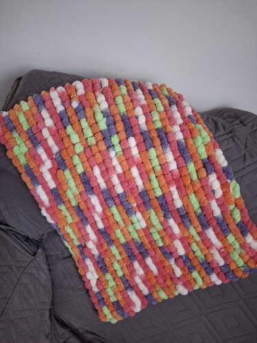 Hand knitted pompom blanket-