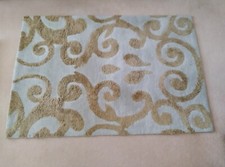 Next Rug. Teal background with