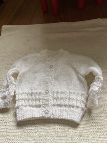 Hand knitted white baby - hand,
