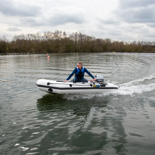 Inflatable dinghy with - , oars