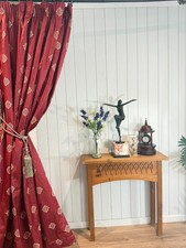 Deep red and brass/gold curtains with traditional embroidered patterns