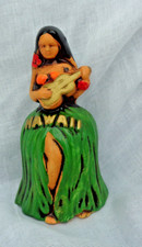 vintage ceramic hand bell depicting a Hawaiian hula girl playing a ukulele
