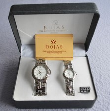 A boxed pair of 'his and hers' Rojas quartz watches