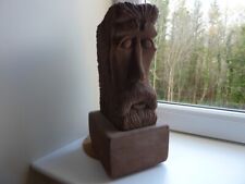 Green Man carved red sandstone with carved bird on the top stand in or outside.