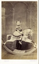 Young girl on large dappled rocking horse with long mane cdv photo