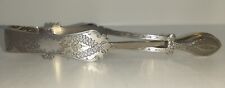 Silver plated sugar tongs with cross over action.