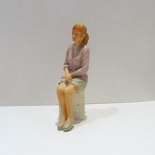 Dolls house miniature resin sitting lady 1/12th scale.