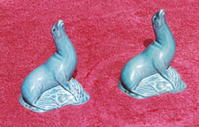 Pair of Poole Pottery seals seal on a rock 11cm high