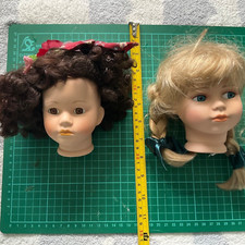 Collection of 2 Bisque Dolls Heads legs and arms.