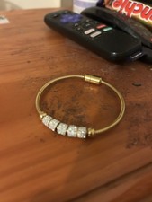 Gold Coloured Metal And Crystal Bangle With Magnetic Clasp