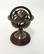 Armillary Sphere Paperweight, brass with a wooden base  |  Thames Hospice