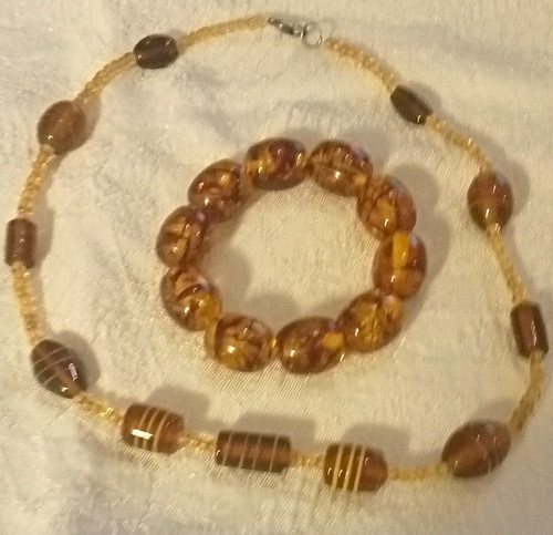 Brown amber coloured oval - &,
