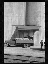 Truck unloading sacks of wheat
