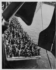 Troops a landing barge, next a