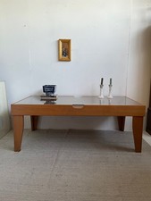 Large coffee table with glass top and cane wicker shelf underneath modernist sty
