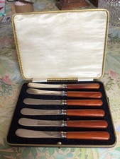 Boxed set of six butter knives. EPNS with brown handles