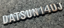 VINTAGE DATSUN 140J METAL CAR BADGE GOOD USED CONDITION FOR AGE
