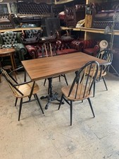 4 Mid Century Ercol Chairs With A Solid Table Top And Cast Iron Legs
