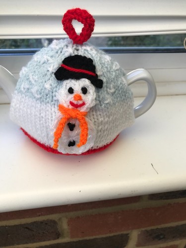 Hand knitted snowman tea - hand,