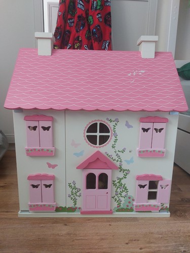 Dolls house furnished with - dolls,