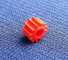 Meccano plastic tri-axle pinion 12 teeth ¼", part 25bp3p, in various colours.