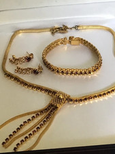 Stunning necklace  earings and bracelet set gold coloured with purple stones