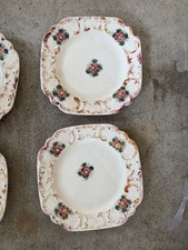 Four Antique Japanese Maruhon Ware ceramic plates with floral motifs.