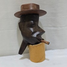 Carved man with hat +cigarette