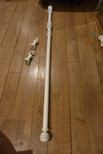A BESPOKE WHITE CURTAIN POLE WITH FINIALS AND CUPS