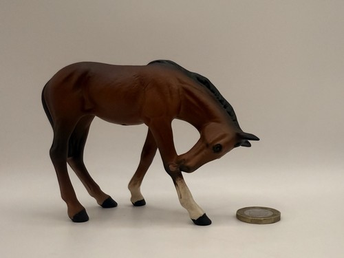 Beswick brown foal licking leg - brown,