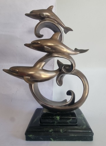 Trio leaping dolphins on - of,