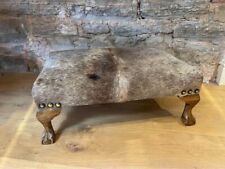 Stunning cowhide footstool on oak ball and claw feet