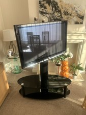 Panasonic Tv and black glass stand 