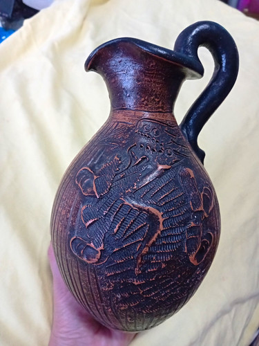 Brown black pottery jug with - &,