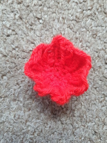 Hand knitted poppy brooch - hand,