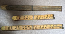 Three folding wooden rulers