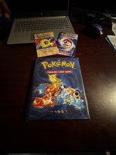 Pokémon 1999 Base Set In Original Binder With Card List And Starter Rules.