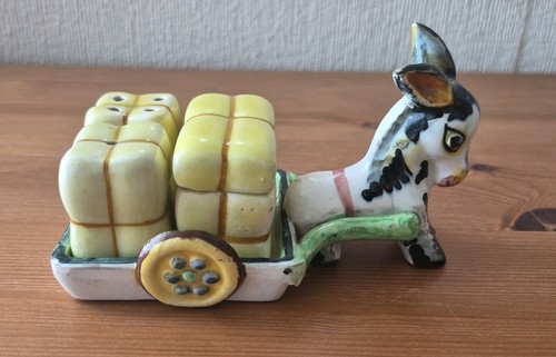 Donkey pulling cart containing - donkey,