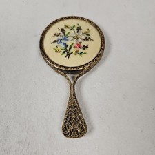 ANTIQUE HAND MIRROR WITH BRASS FILIGREE HANDLE AND FRAME EMDRIODERED FLORAL BACK