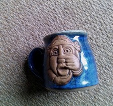 blue glazed chunky ,grey glaze inside, vgc pottery mug with face design on front