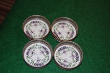 A set of 4 Pretty vintage Ceramic metal framed coasters
